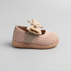 Side view of peach-colored knit baby Mary Jane shoe