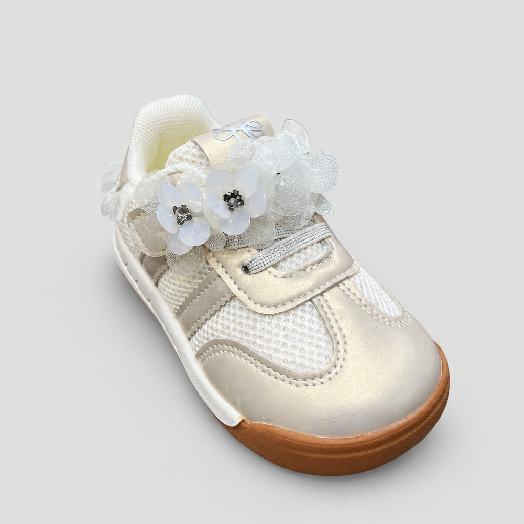 Top-down view of cream metallic toddler sneakers showing floral lace embellishments
