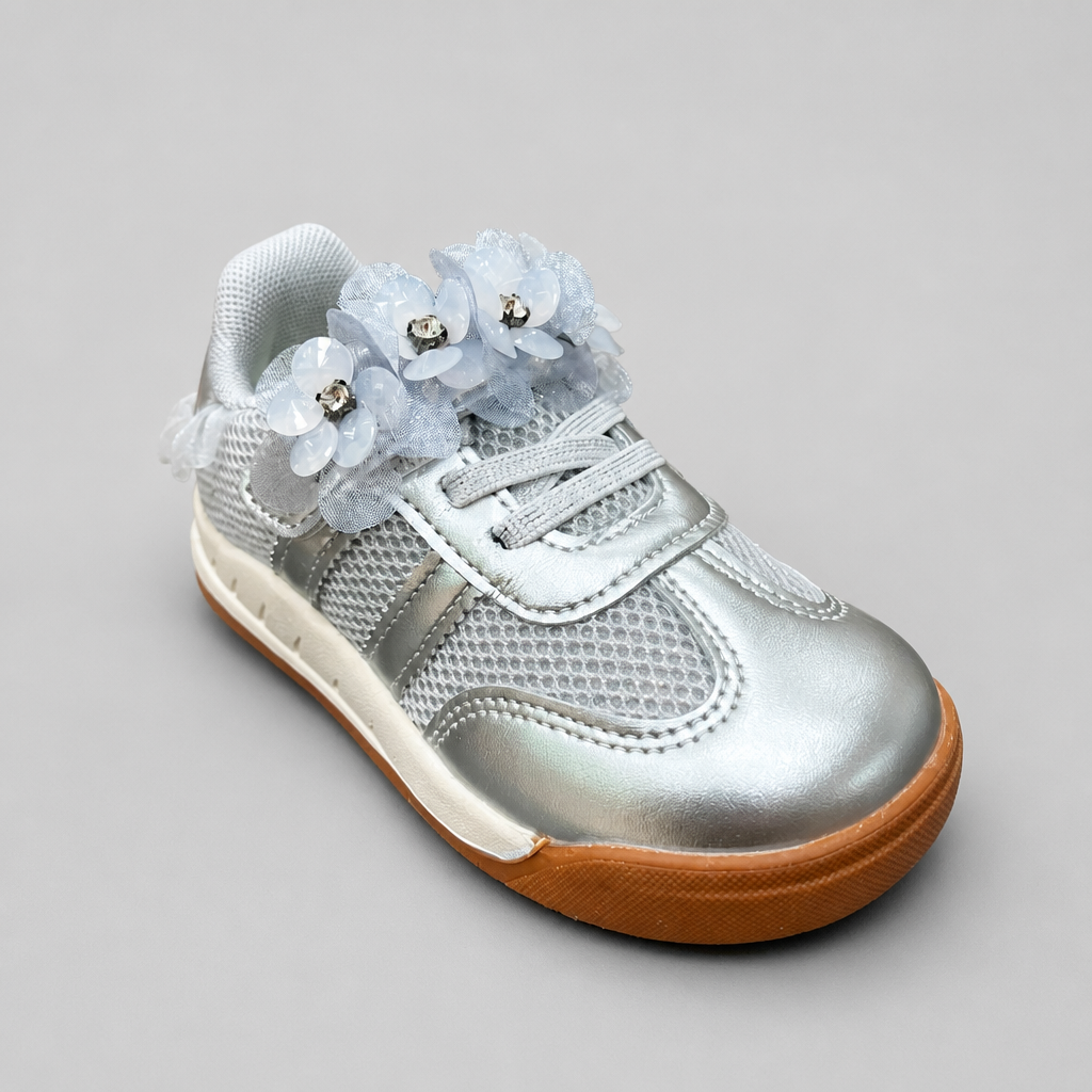 Angled view of toddler metallic silver sneakers decorated with light blue mesh flowers