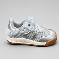 Side profile of shiny silver toddler girls sneakers with floral lace strap accents